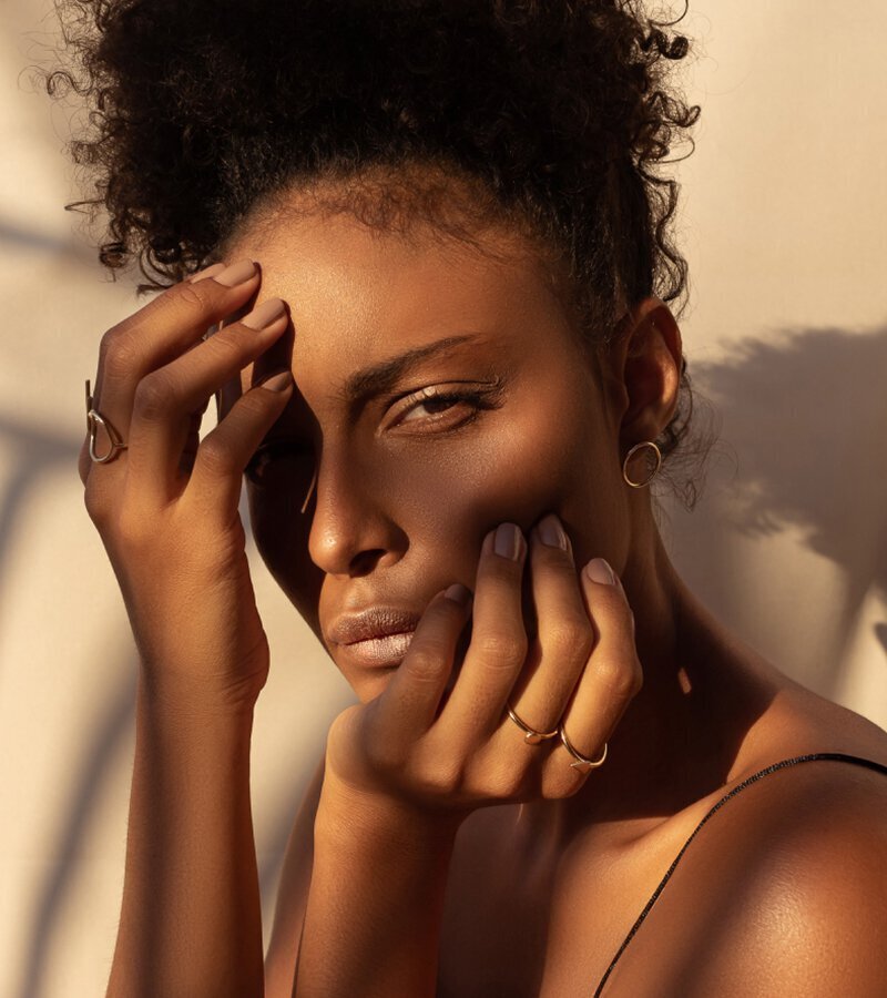 beverly hills injectables model with hands on face